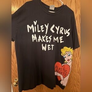 MILEY CYRUS Black Graphic T-Shirt with Bold Text and Cartoon Design